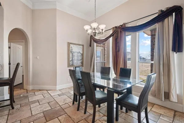 a view of a dining room with furniture and a chandelier