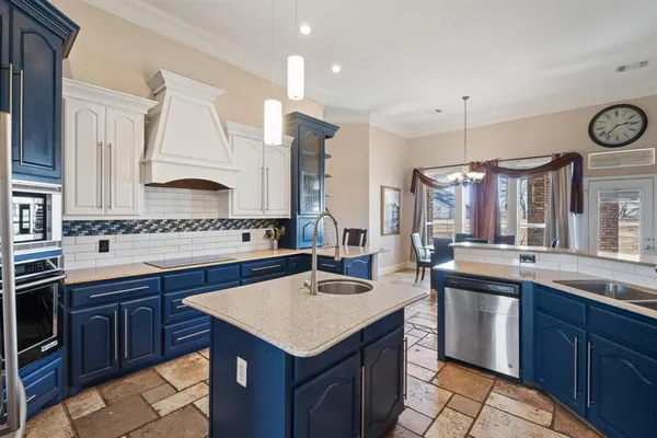 a kitchen with granite countertop a sink and cabinets