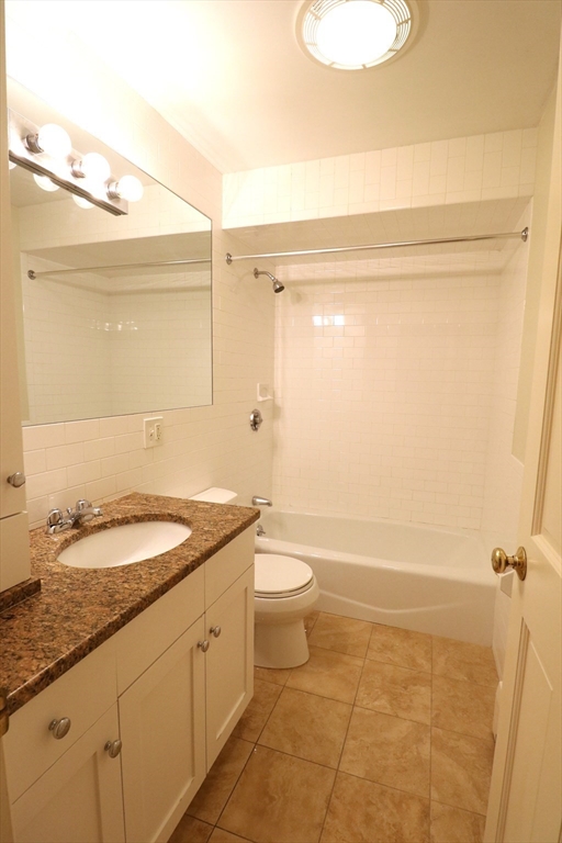 8 Caldwell Avenue, Unit 2 Somerville, MA 02143 - Photo 11 of 16 a bathroom with a granite countertop sink toilet and shower