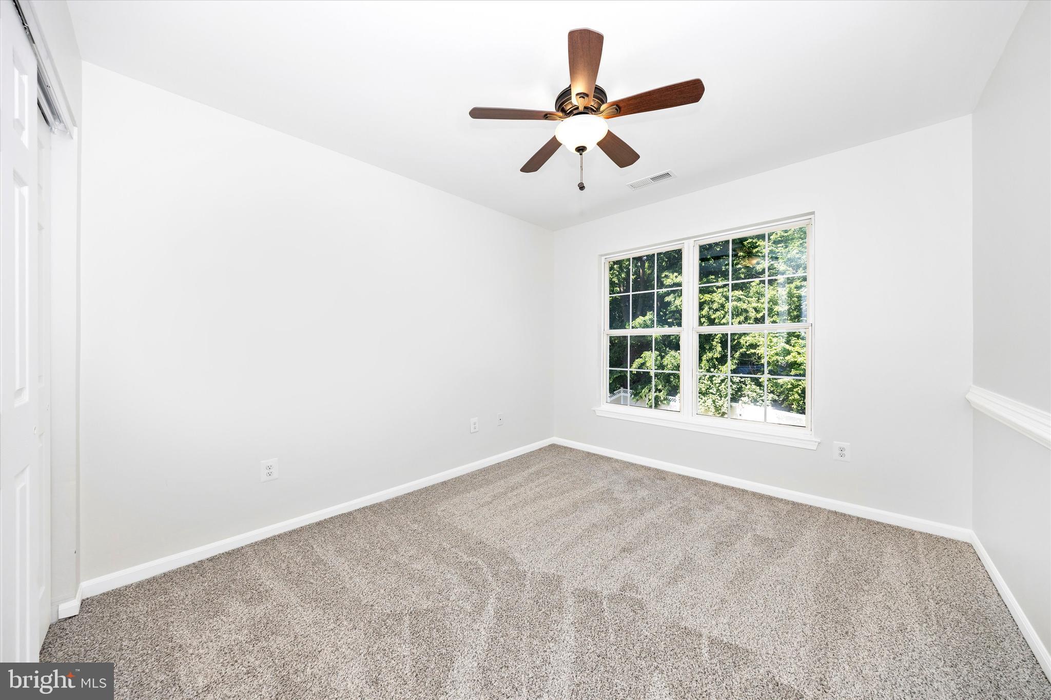 803 Apache Court Frederick, MD 21701 - Photo 26 of 46 an empty room with ceiling fan and window