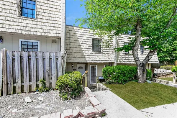 a view of a house with a yard and sitting area