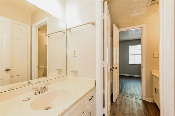 a en suite bathroom with a sink a mirror and a shower