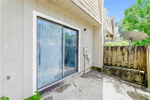 a view of a balcony with a potted plant and a large window