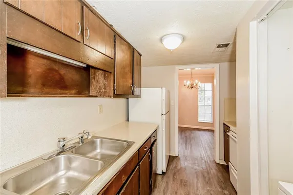 a bathroom with a sink a mirror and wooden floor
