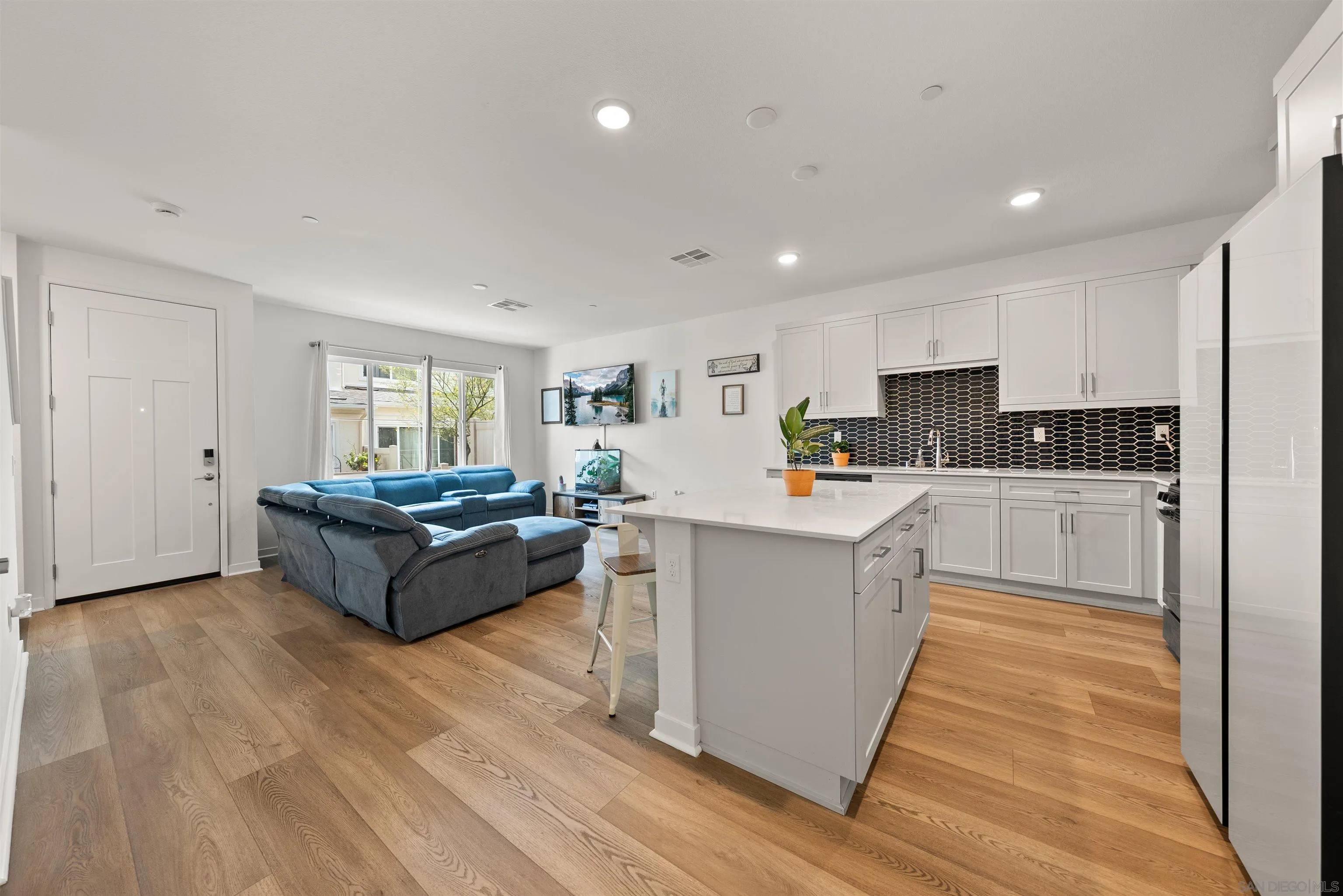323 Satsuma Trail Fallbrook, CA 92028 - Photo 3 of 28 a kitchen with cabinets and wooden floor