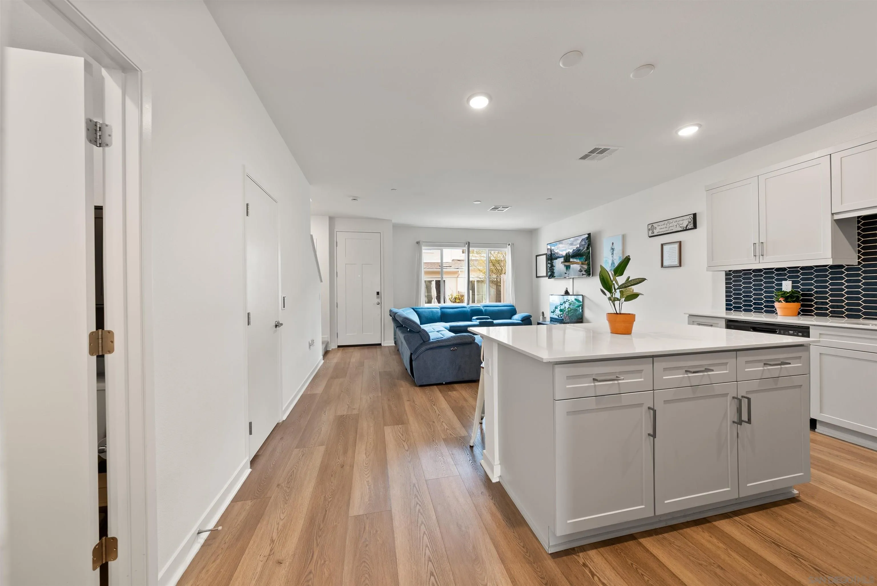 323 Satsuma Trail Fallbrook, CA 92028 - Photo 5 of 28 a kitchen with white cabinets and white appliances