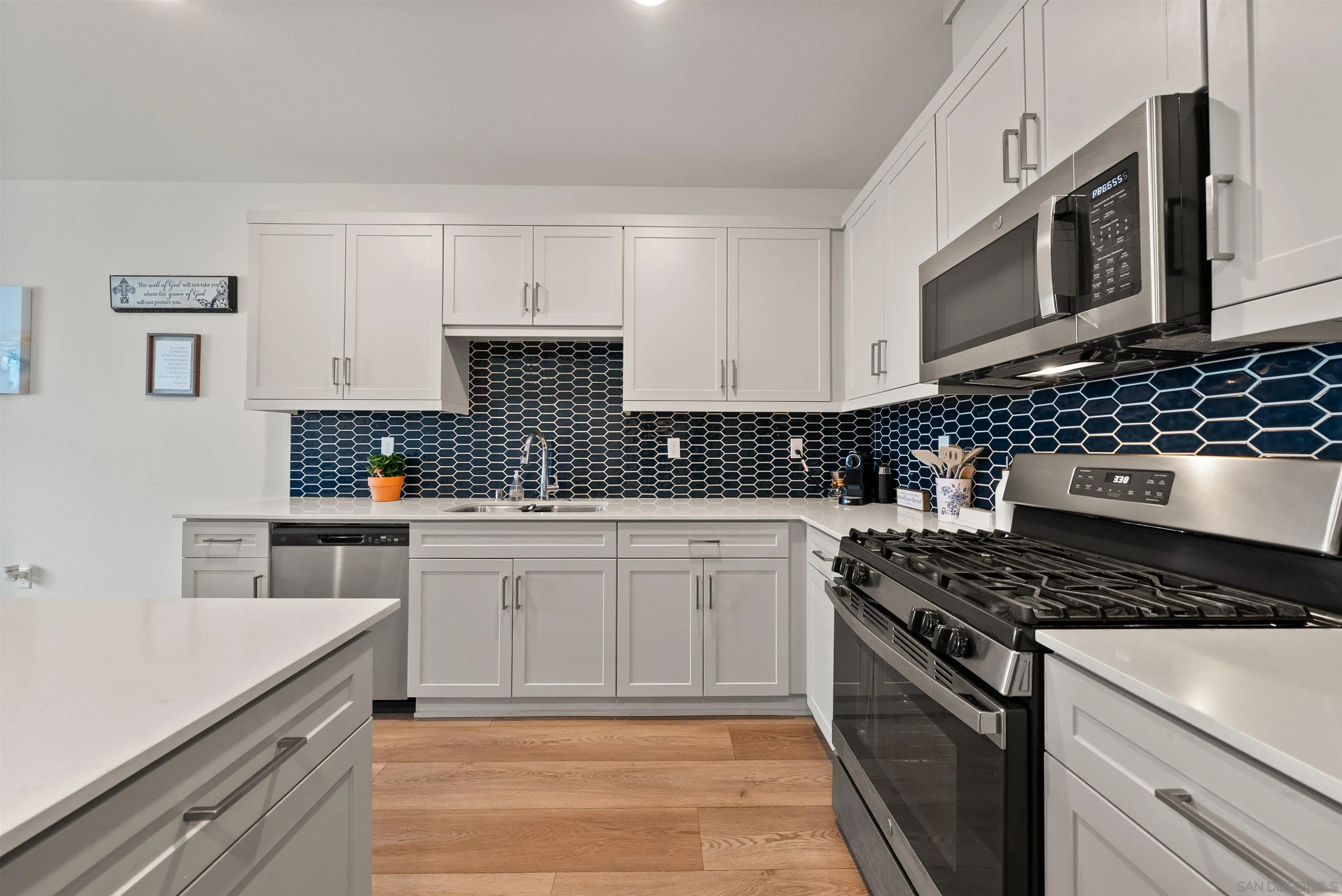 323 Satsuma Trail Fallbrook, CA 92028 - Photo 7 of 28 a kitchen with stainless steel appliances granite countertop a stove and a microwave