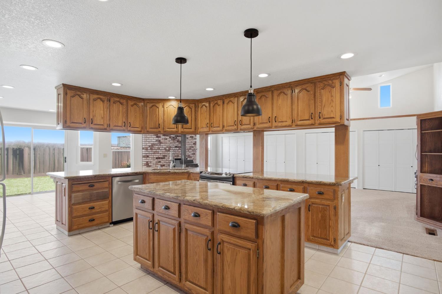 16166 Lawrence Road Escalon, CA 95320 - Photo 11 of 56 a kitchen with stainless steel appliances granite countertop a sink and a refrigerator