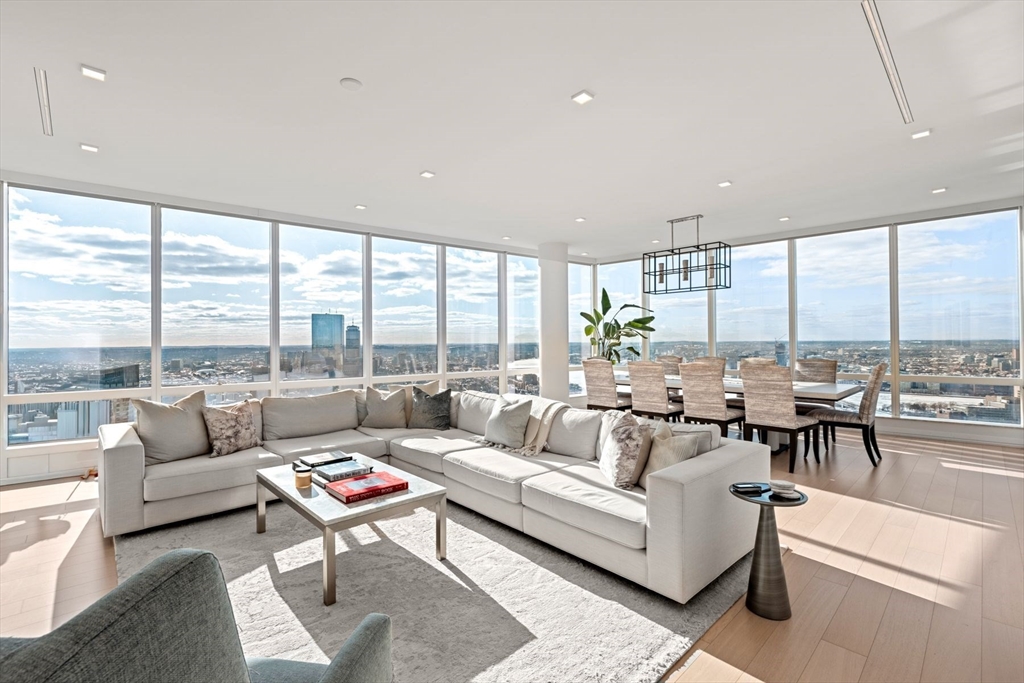 a living room with furniture and floor to ceiling windows