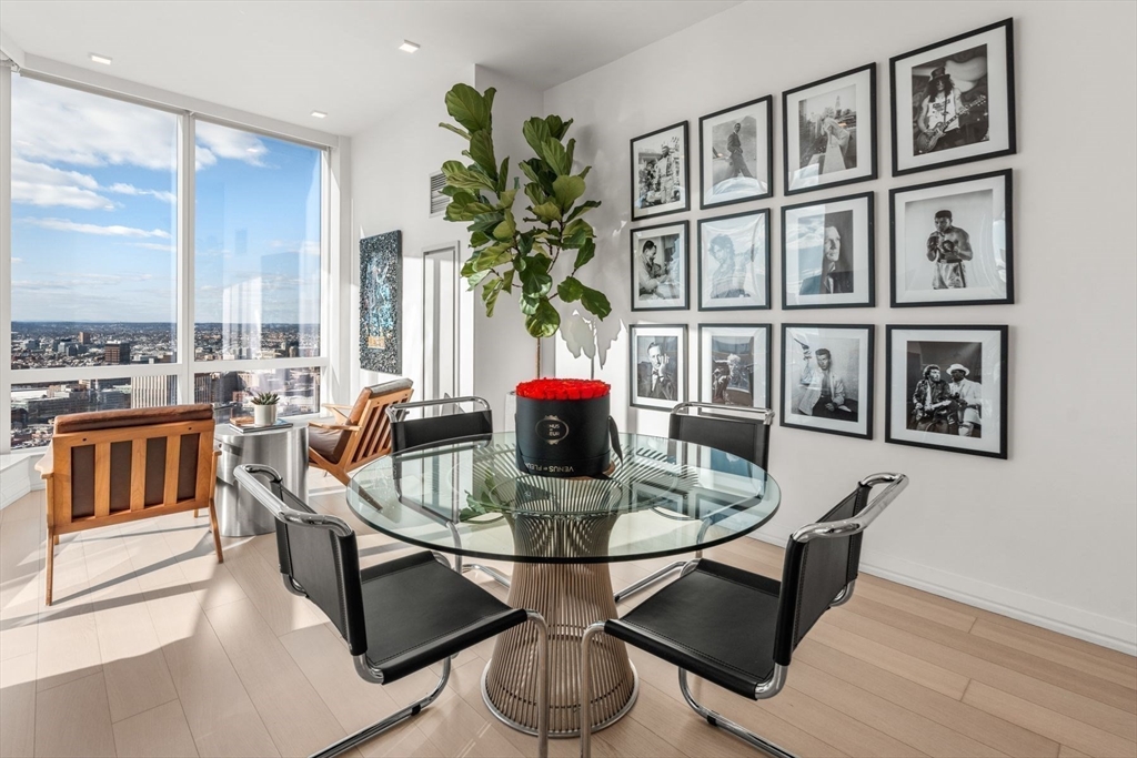 1 Franklin Street, Unit 5002 Boston, MA 02110 - Photo 11 of 40 a dining room with furniture potted plants and wooden floor