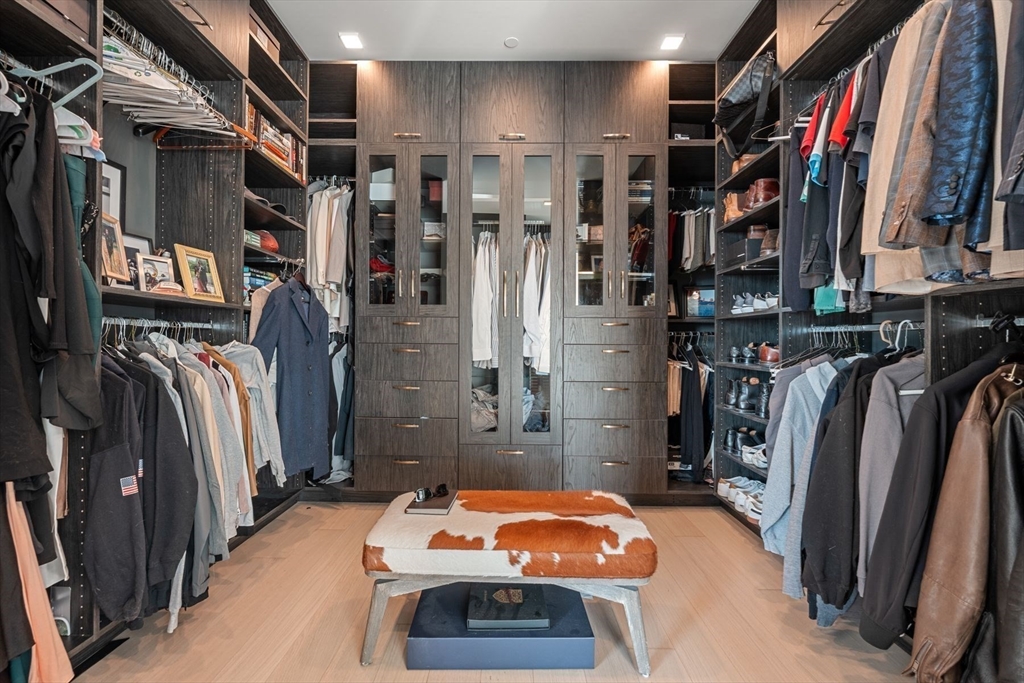 1 Franklin Street, Unit 5002 Boston, MA 02110 - Photo 22 of 40 a view of walk in closet with clothes and shoes