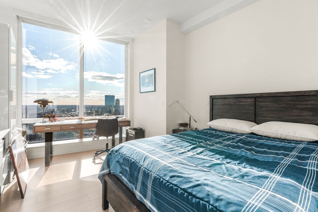 1 Franklin Street, Unit 5002 Boston, MA 02110 - Photo 25 of 40 a bedroom with a large bed and a night stand