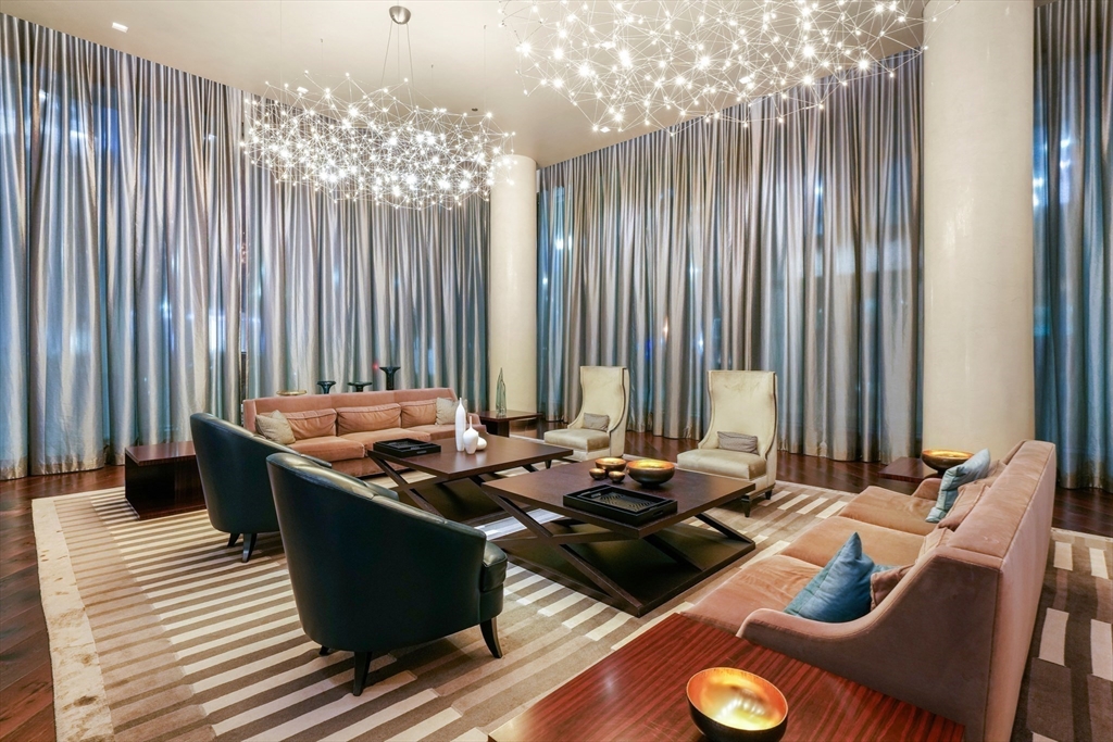 1 Franklin Street, Unit 5002 Boston, MA 02110 - Photo 39 of 40 a table with chairs and stove in it