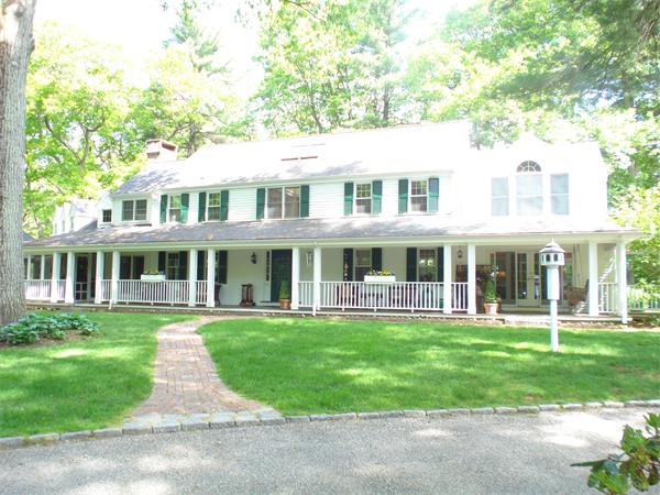 97 Cherry Brook Road Weston, MA 02493 - Photo 18 of 18 a front view of a house with a yard table and chairs