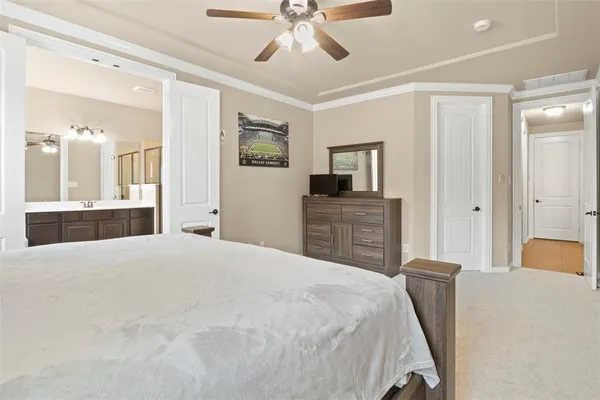 a spacious bedroom with a bed and a chandelier