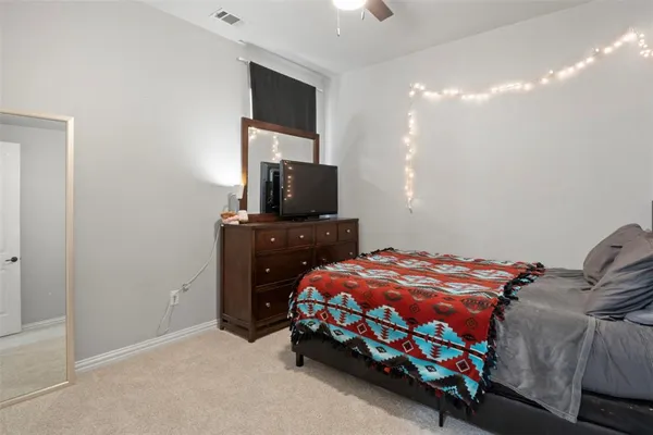 a bedroom with a bed and flat screen tv