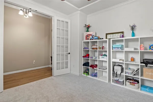 a room with a bookshelf and a window