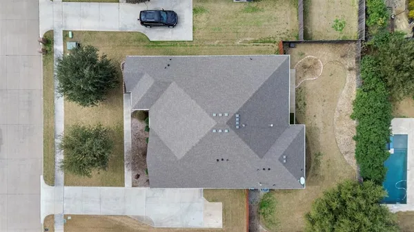 an aerial view of a house with a yard