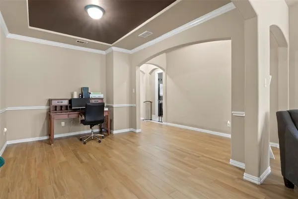 a view of a workspace with furniture and wooden floor