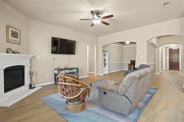 a living room with furniture a flat screen tv and a fireplace