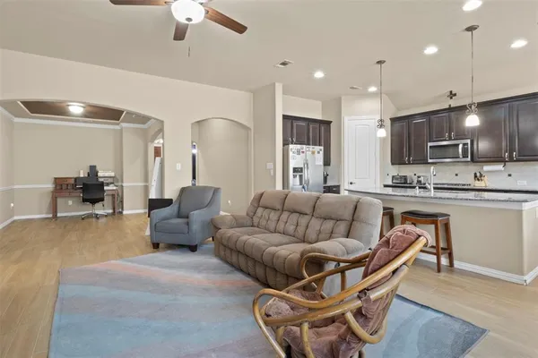 a living room with furniture and kitchen view