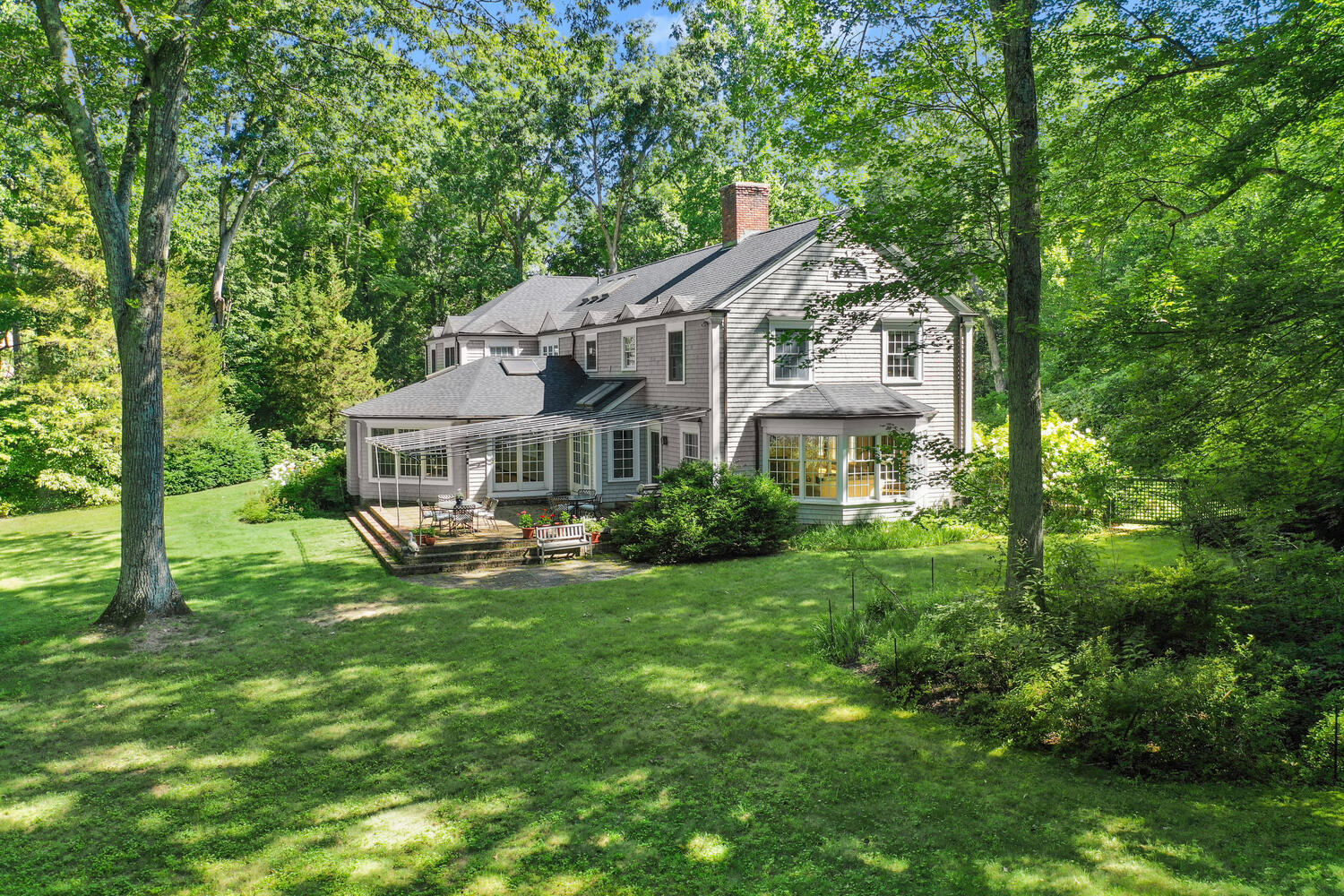 216 Turtle Back Road New Canaan, CT 06840 - Photo 31 of 38 a front view of a house with a garden