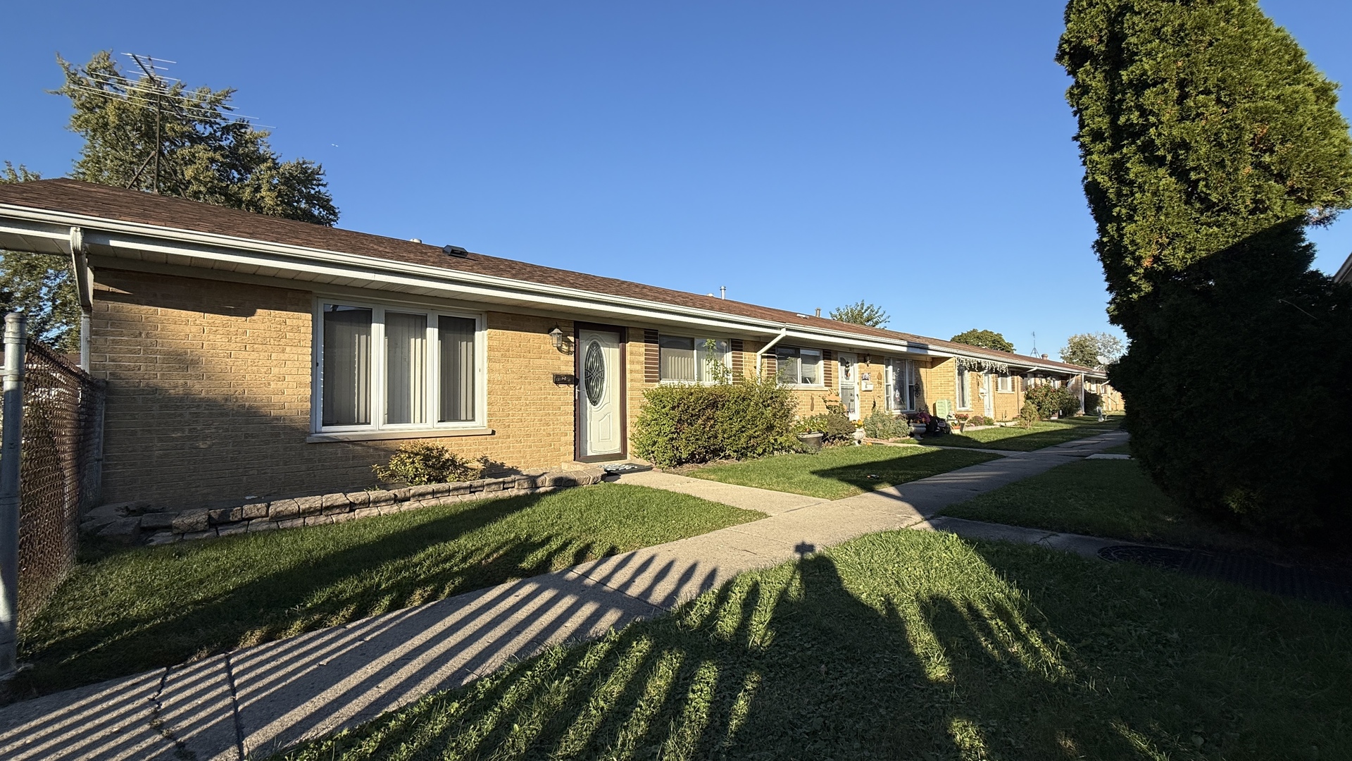 9457 Sumac Road, Unit E Des Plaines, IL 60016 - Photo 2 of 17 a front view of a house with garden