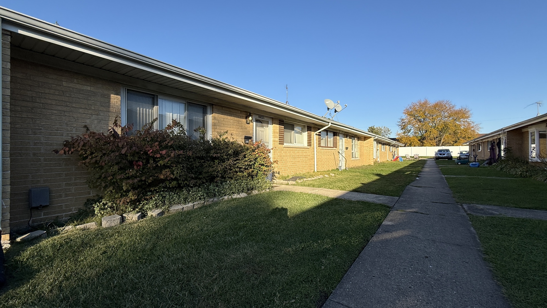 9457 Sumac Road, Unit E Des Plaines, IL 60016 - Photo 4 of 17 a front view of a house with garden