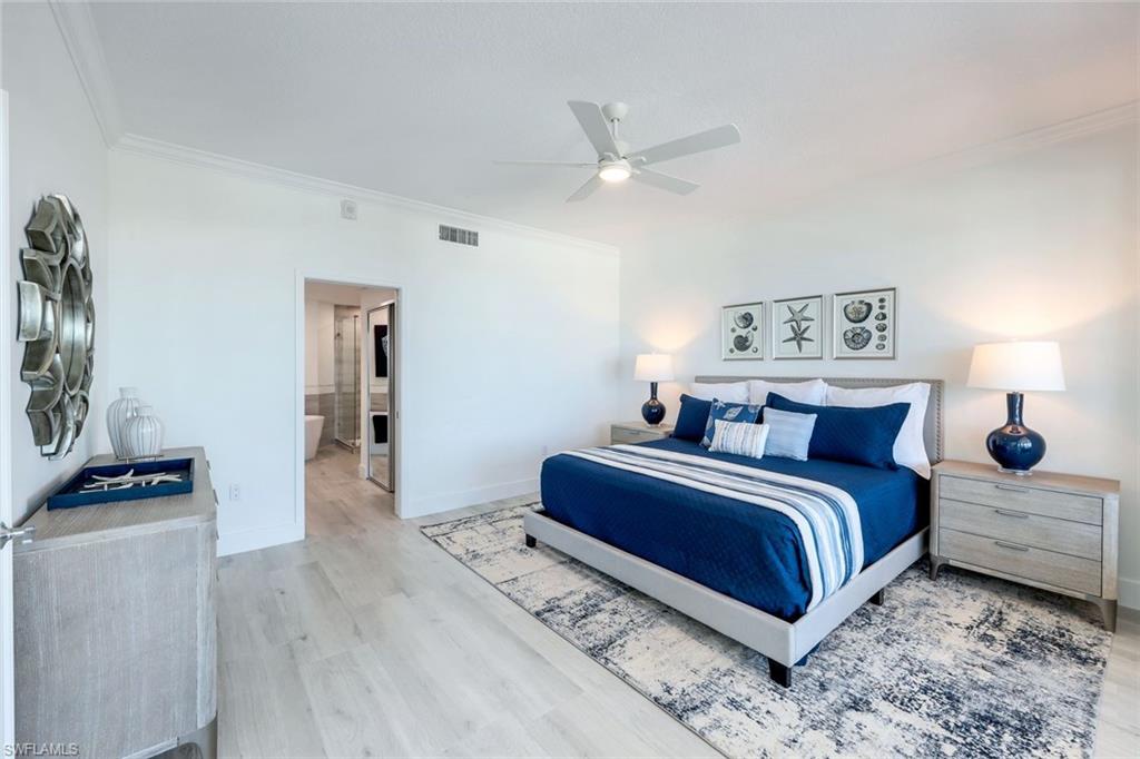 269 Barefoot Beach Boulevard, Unit 403 Bonita Springs, FL 34134 - Photo 12 of 27 Bedroom featuring ornamental molding, wood finished floors, baseboards, a ceiling fan, and connected bathroom