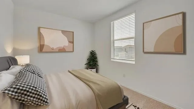 a bedroom with a bed and a painting on the wall