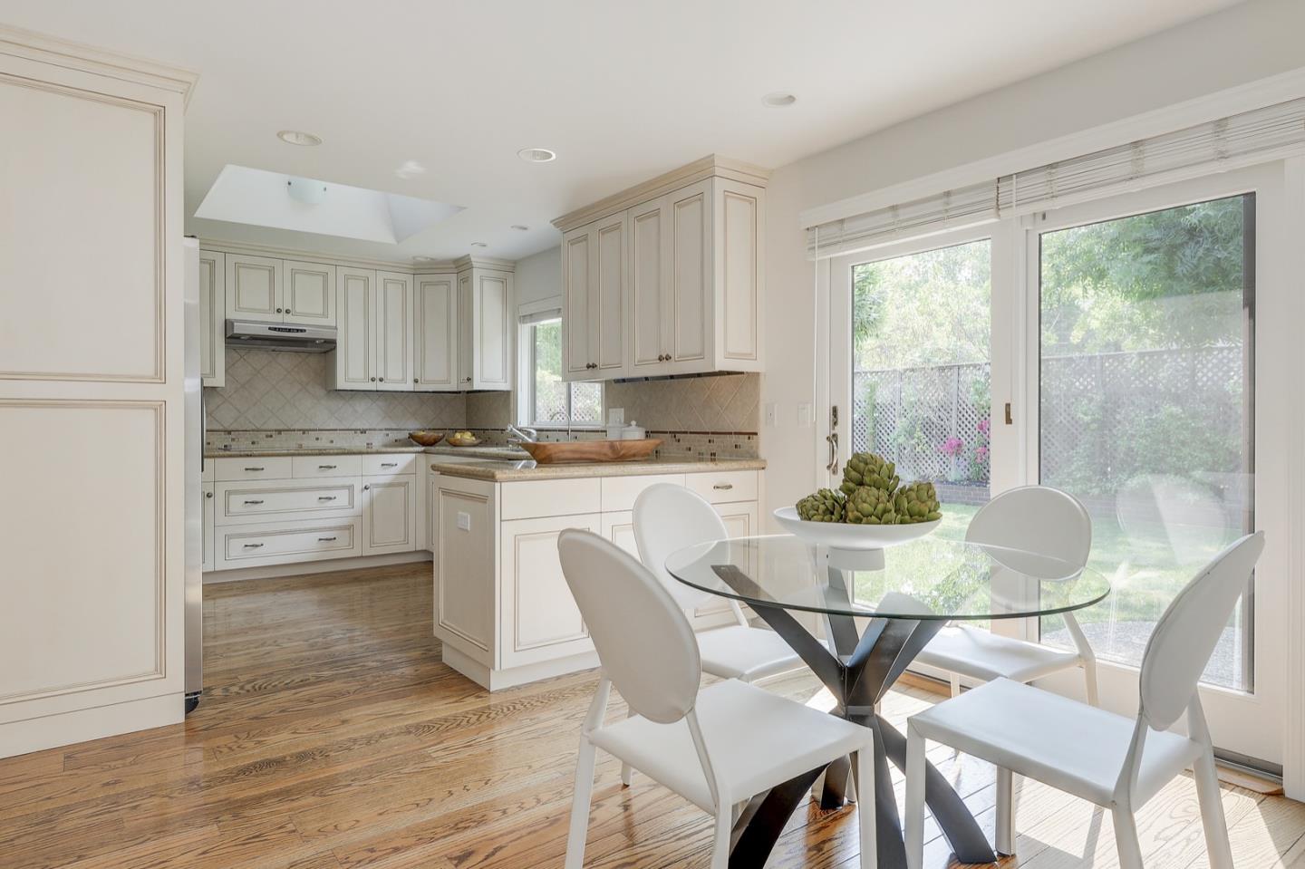 190 Pine Lane Los Altos, CA 94022 - Photo 12 of 30 a kitchen with a table chairs a sink and cabinets