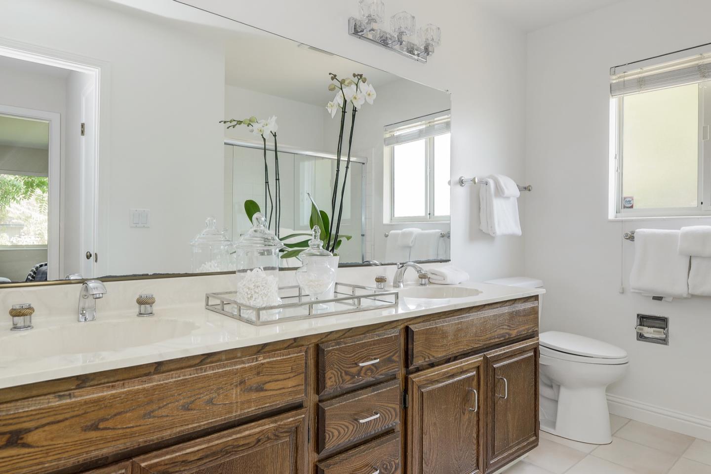 190 Pine Lane Los Altos, CA 94022 - Photo 20 of 30 a bathroom with a granite countertop sink a toilet and mirror