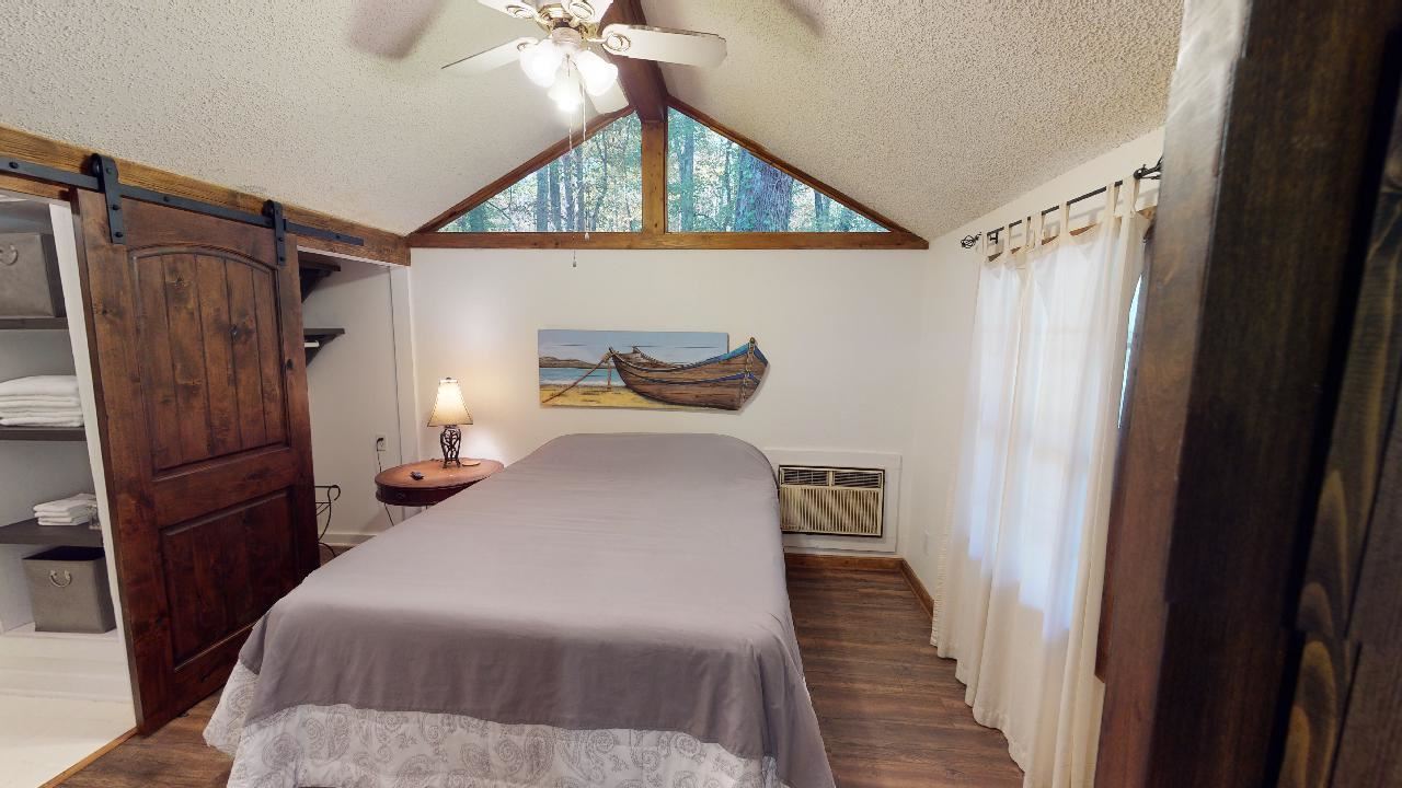 190 Micro Lane Counce, TN 38326 - Photo 13 of 25 a bedroom with a bed and wooden floor