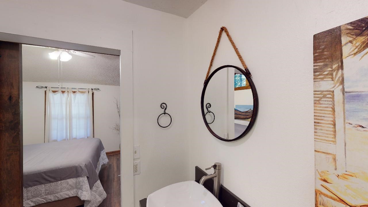 190 Micro Lane Counce, TN 38326 - Photo 14 of 25 a bathroom with a toilet mirror and tub