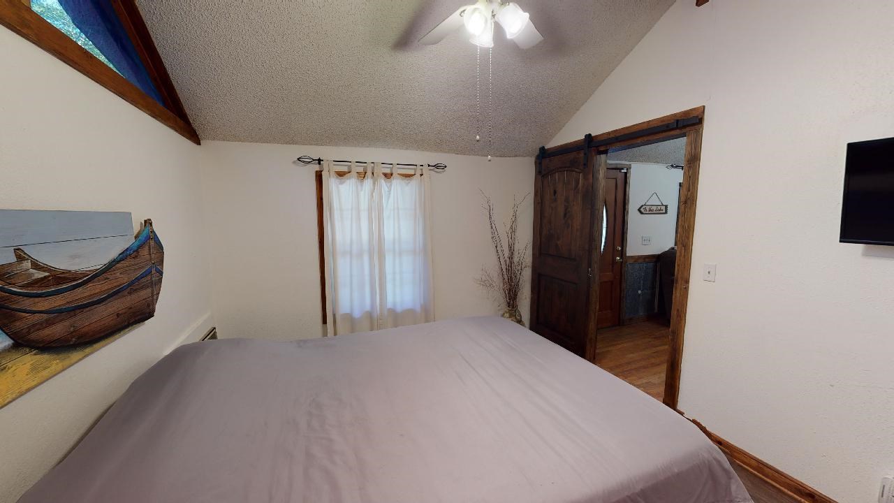 190 Micro Lane Counce, TN 38326 - Photo 16 of 25 a bedroom with a bed and a television