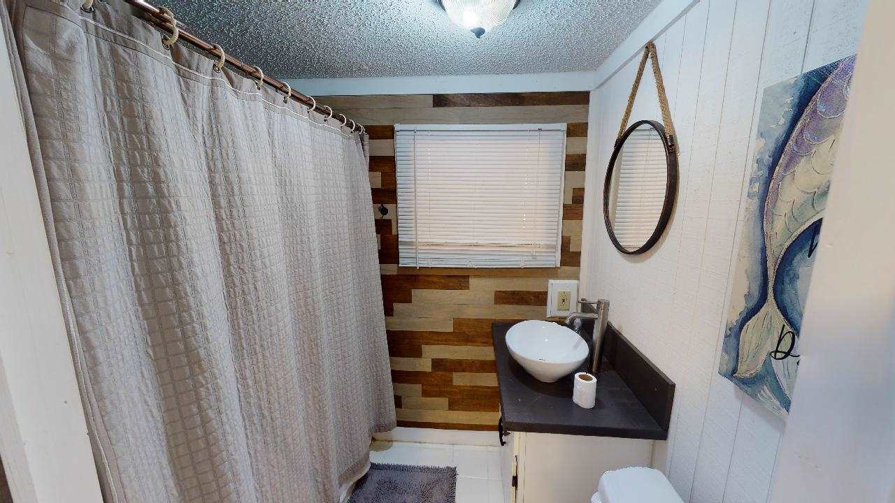 190 Micro Lane Counce, TN 38326 - Photo 18 of 25 a bathroom with a sink a mirror and a shower