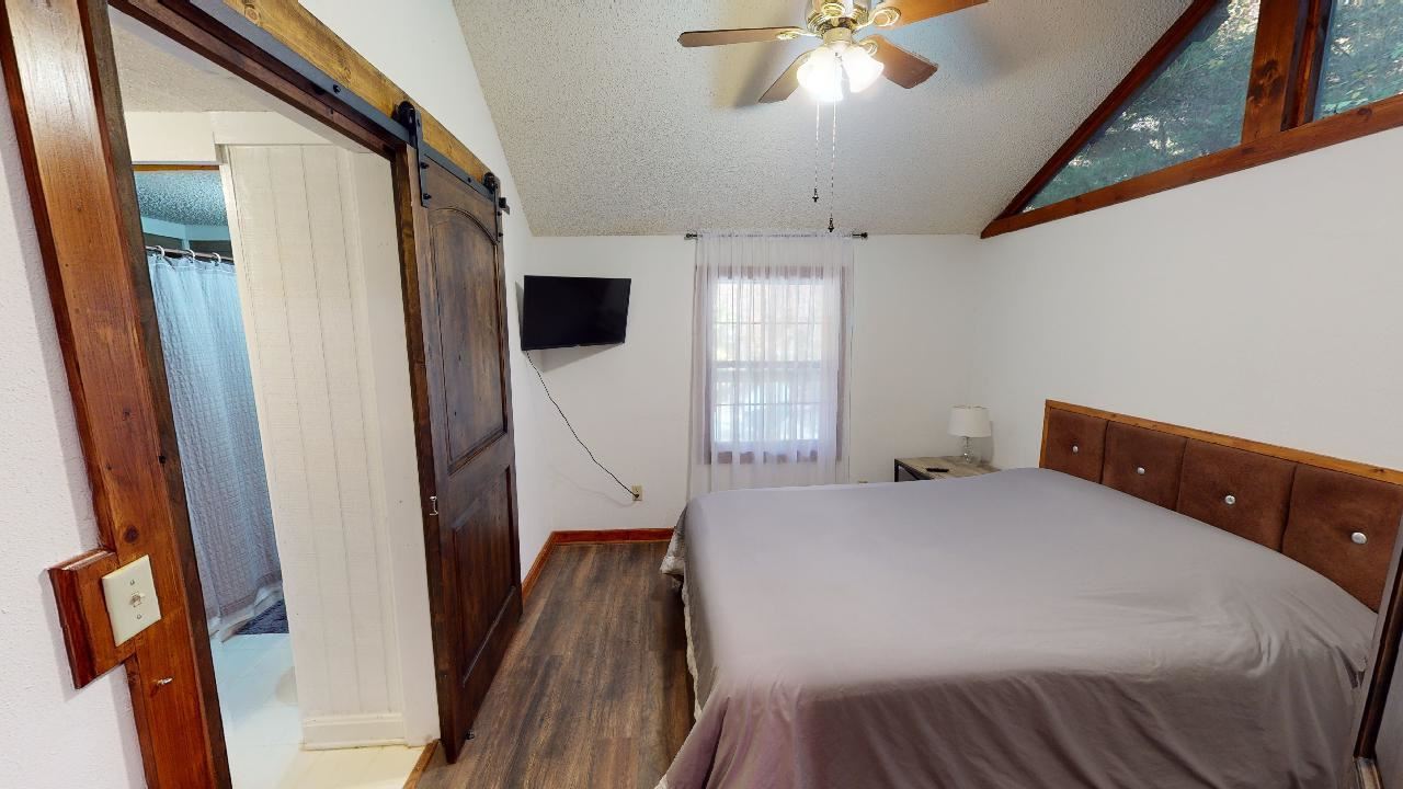 190 Micro Lane Counce, TN 38326 - Photo 20 of 25 a bedroom with a bed and a flat tv screen