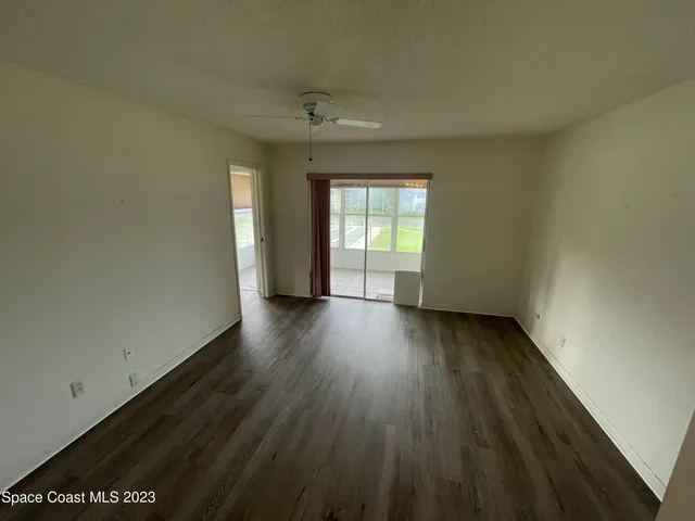 a view of a room with wooden floor