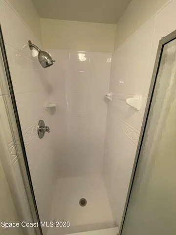 a bathroom with a granite countertop sink a toilet and a mirror