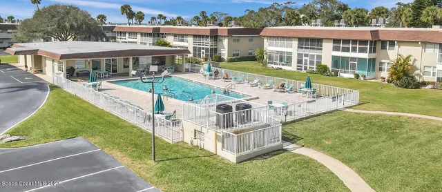 a view of a patio with a table and chairs