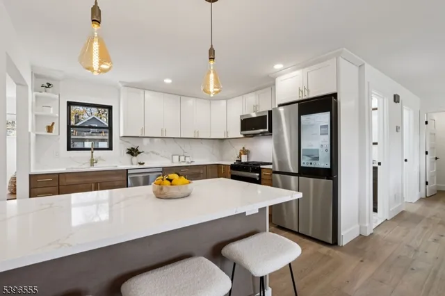 a kitchen with a refrigerator a sink and a stove