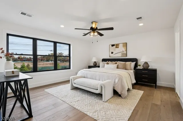 a bedroom with a bed and a large window