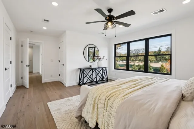 a bedroom with a large bed and a large window