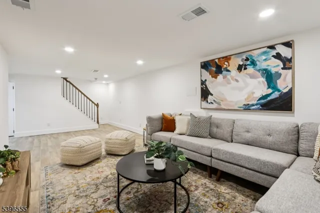 a living room with furniture and a painting