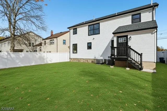a view of a backyard with plants and a tree