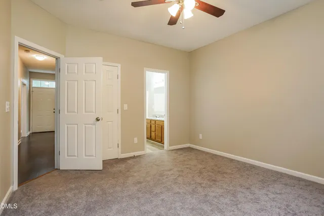 an empty room with chandelier fan
