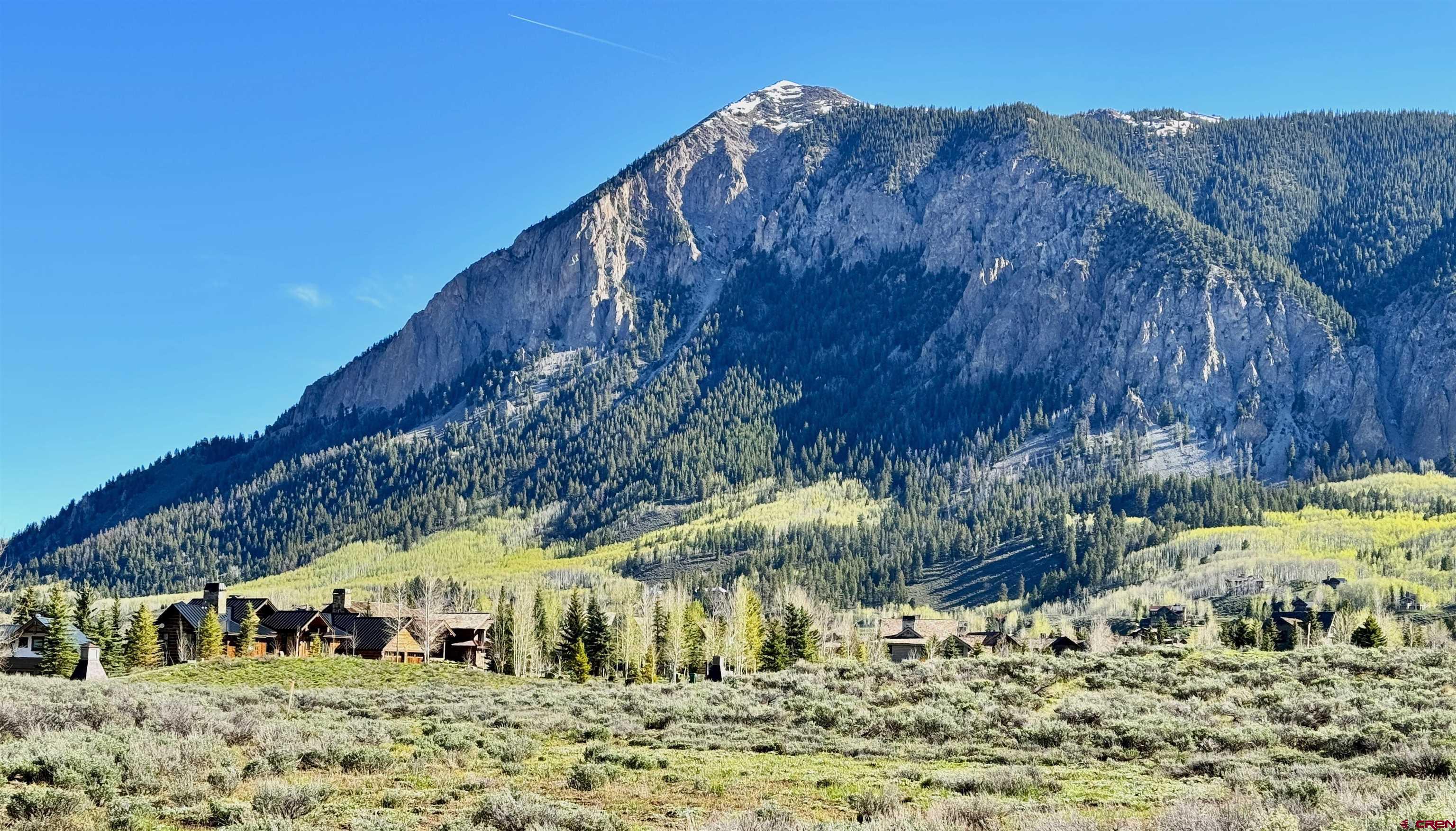 91 Larkspur Loop Crested Butte, CO 81224 - Photo 6 of 10 a view of a large building with a mountain in the background