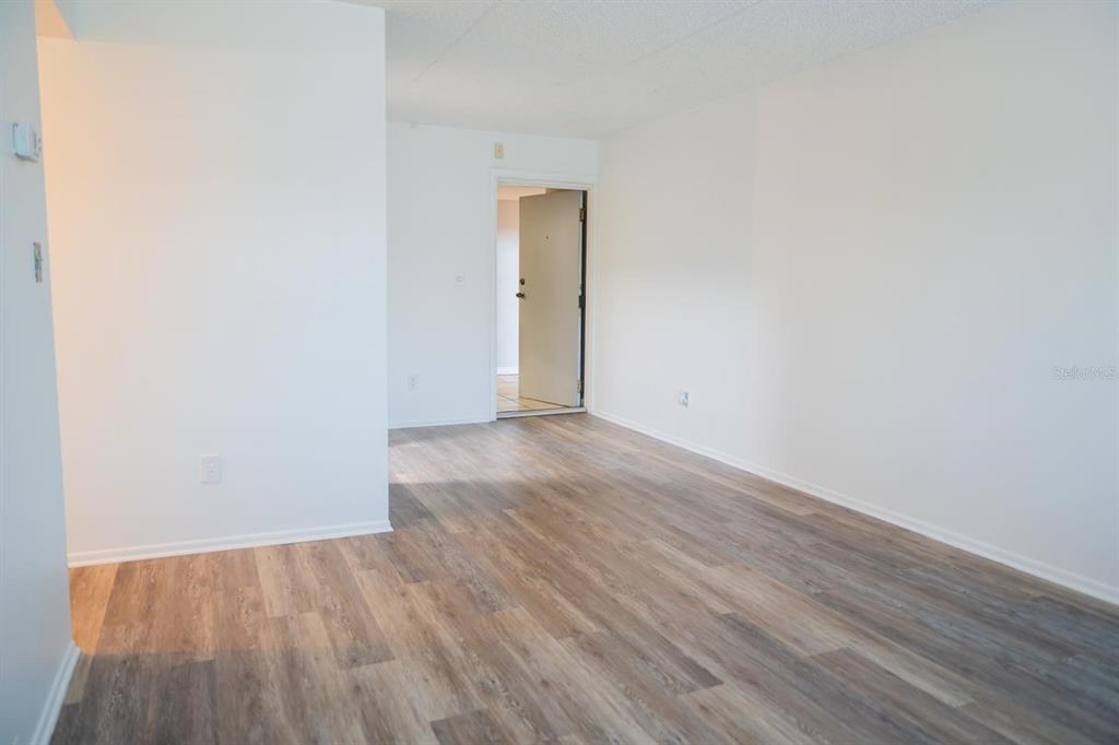 1902 Honour Road, Unit 23 Orlando, FL 32839 - Photo 11 of 19 a view of an empty room with wooden floor and a window