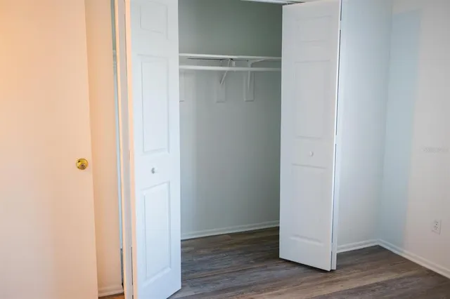 a view of walk in closet with empty racks