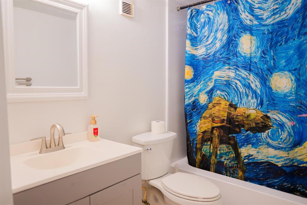 1902 Honour Road, Unit 23 Orlando, FL 32839 - Photo 16 of 19 a bathroom with a sink toilet and mirror